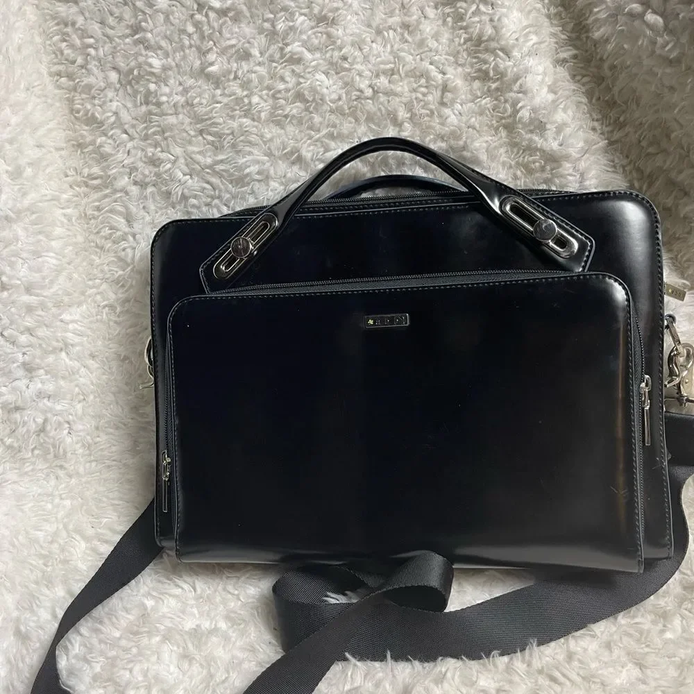Abbi New York Laptop/Briefcase Carrier Black leather inside padded fabric.